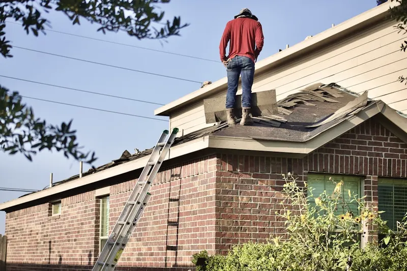 Professional roofer working on a residential roof in Porter Square